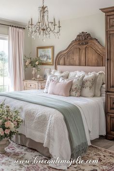 a bedroom with a bed, dresser and chandelier