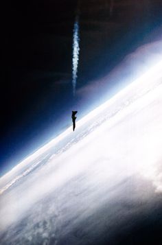 a person standing on the edge of a space station