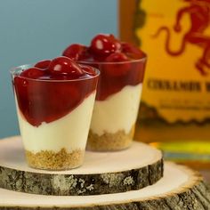 two desserts with cherries are sitting on a plate