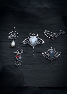 six pieces of jewelry sitting on top of a wooden table