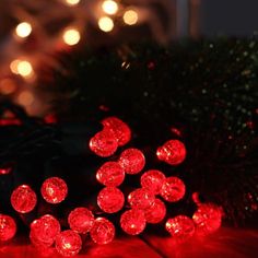 red christmas lights sitting on top of a wooden table