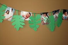 a garland with leaves and photos hanging from it