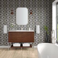 a white bath tub sitting next to a bathroom sink under a mirror on top of a wooden cabinet