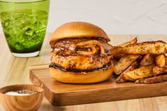 a burger and french fries on a cutting board