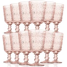 six pink glass goblets sitting on top of each other