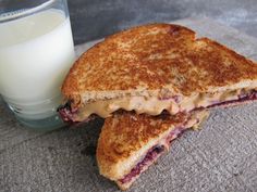 a grilled cheese sandwich next to a glass of milk