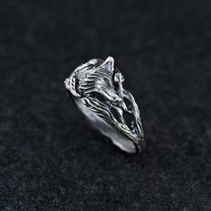 Embrace the cunning and mystique of the wild with this sterling silver fox ring, perfect for those who feel a connection to the clever and elusive fox. The intricately detailed fox head represents intelligence, adaptability, and wisdom, making it a meaningful talisman for anyone who values these traits. Handcrafted with precision, this ring features a textured design and an oxidized finish to enhance the lifelike appearance of the fox. Ideal for fans of Celtic and Nordic symbolism, this ring can Silver Wolf Design Ring As Gift, Silver Ring With Wolf Design, Silver Wolf Ring, Fox Ring Gold, Silver Fox Ring, Fox Ring, Fox Jewelry, Winter Jewelry, Silver Fox