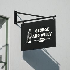 a sign hanging from the side of a building that says george and willy on it