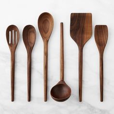 wooden utensils lined up on a marble surface