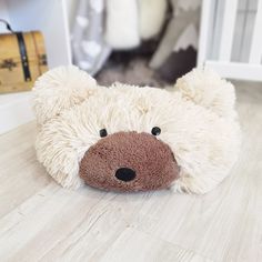 a teddy bear is laying on the floor