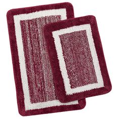 two red and white bathroom rugs on top of each other, one with an area for