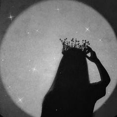 the silhouette of a woman with a crown on her head is shown in front of a full moon