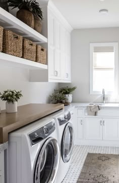 a washer and dryer in a white laundry room