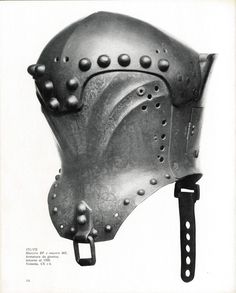 an old helmet with metal rivets on the face and side, in black and white