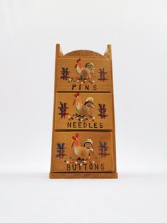 This is a small set of vintage 1950s or 60s wood organizer drawers for sewing. Each of the three drawers is painted with a rooster and labeled for either pins, needles, or buttons. It has a little hole at the top of the back panel so it can be hung on a nail. Sewing Organizer, Organizer Drawers, Rooster Painting, Organize Drawers, Sewing Organization, Painted Wood, Painting On Wood