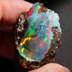 a hand holding a piece of opalite in it's palm