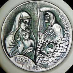 a silver coin with an image of the virgin mary and jesus holding a baby jesus