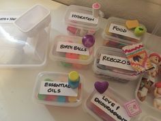 several plastic containers filled with different types of toys and food items on a counter top