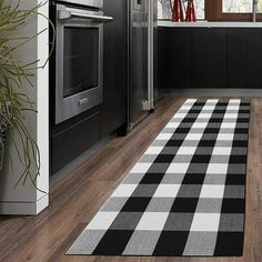 a black and white checkered rug in a kitchen