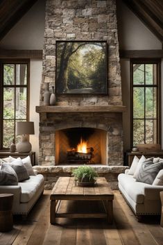 a living room with two couches and a fire place in the middle of it