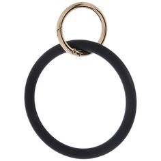 the black and gold ring is hanging on a white wall, with an open end