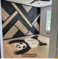 a panda bear rug is on the floor in front of a black and white wall