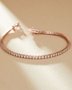 Adorn your wrist with this luxurious Rose Gold Tennis Bracelet, perfect for everyday elegance or special occasions. Crafted from high-quality 14k rose gold, this stunning bracelet features 3.00 carats of sparkling lab grown diamonds, making it a truly dazzling piece. Its timeless and sophisticated design ensures it will complement any outfit, whether casual or formal. Details: - Material: 14k Rose Gold - Weight: 7.2 grams of gold - Diamond Carat Weight: 3.00 carats total - Clasp: Secure Box Clas Rose Gold Tennis Bracelet For Anniversary, Anniversary Fine Jewelry Rose Gold Tennis Bracelet, Rose Gold Tennis Bracelet, Fine Jewelry Rose Gold Tennis Bracelet For Wedding, Rose Gold 14k Gold Bracelet, Rose Gold 14k Bracelet, Elegant Rose Gold Tennis Bracelet With Prong Setting, Rose Gold Tennis Bracelet For Formal Occasions, Luxury Rose Gold 14k Tennis Bracelet