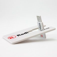 two white toothbrushes sitting next to each other on top of a white surface