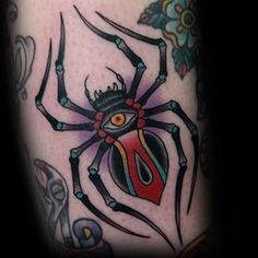 a tattoo with a spider on it's leg