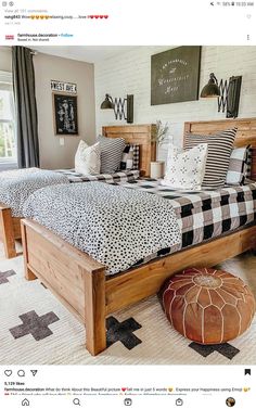 a bedroom with two beds and pillows on top of the bed is decorated in black and white