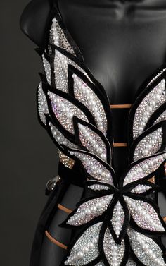 the back of a dress with white and black wings on it