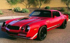 a red sports car parked in front of a building