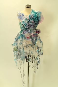 a mannequin is covered with fabric and flowers