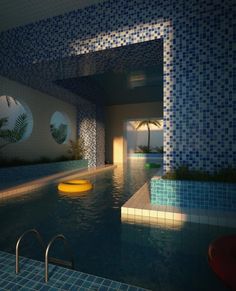 an indoor swimming pool with tiled walls and blue tiles