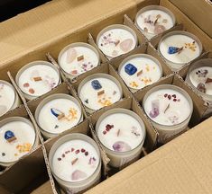 a box filled with lots of white candles