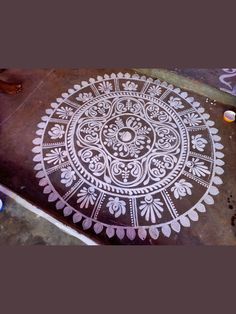 an intricately designed design is shown on the ground