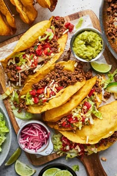 tacos and guacamole on a cutting board