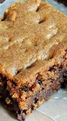 two pieces of brownie sitting on top of a piece of wax paper