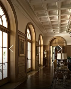 an elegant living room with high ceilings and large windows