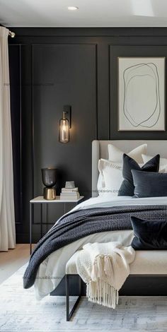 a bedroom with black walls and white bedding in the center is an art work on the wall