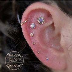 an ear with three different piercings on it