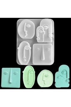 four different shapes and sizes of plastic molds on a black background, with one in the middle