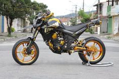 a black and gold motorcycle parked on the street