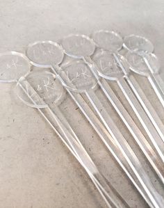 six clear plastic utensils sitting on top of a table