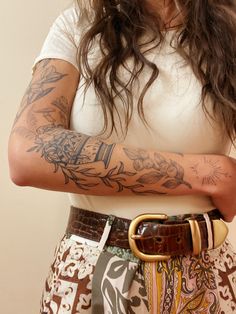 a woman with tattoos on her arm and arms