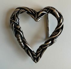 A super rad buckle. The design s a cutout heart made with barbed wire/electrical wires. Truly unique piece. Designed to be worn with 1.5' (38mm) belt strap. Plated in silver with blackened details. Buckle Bunnies, Wire Electrical, Barbed Wire Heart, Homesteading Animals, Cool Belt Buckles, Buckle Bunny, Electrical Wires, Wire Heart, Barbed Wire