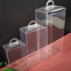 three clear boxes sitting on top of a table