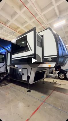 an rv parked in a garage with the door open to show it's interior