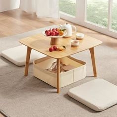 a wooden table with two trays on it and some fruit in the basket next to it