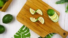 limes cut in half on a cutting board